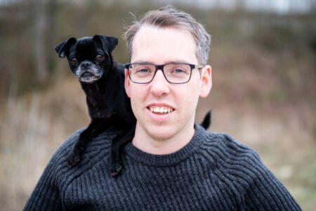 Mann mit Hund auf der Schulter, verspieltes Portrait – Fotograf aus Heilbronn